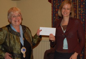 Jean Naish presents the cheque to Helen Carter