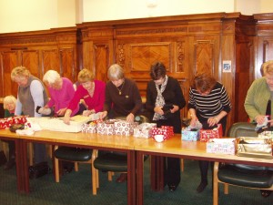 Members filling the boxes during a meeting.