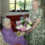 90th Birthday Party for Mona Hall. Betty Dobson presenting a bouquet.