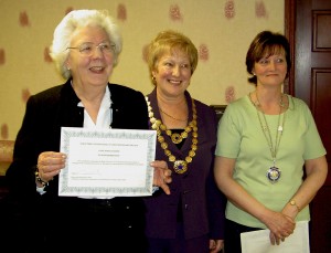 Betty receiving her long service award. From left, Betty, Pat Shore regional president and Sue Fenwick, club president.