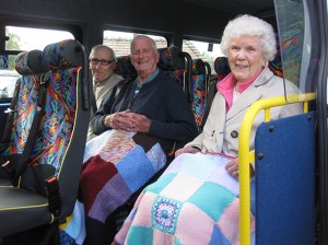 Three St. John's clients on the mini bus with their new rugs