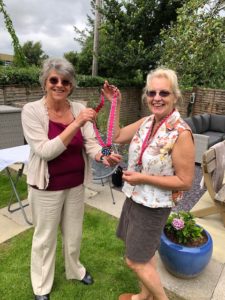 Alex giving out a 10k Virtual Walk medal to Susie at the Tea party we held in Irene`s garden.