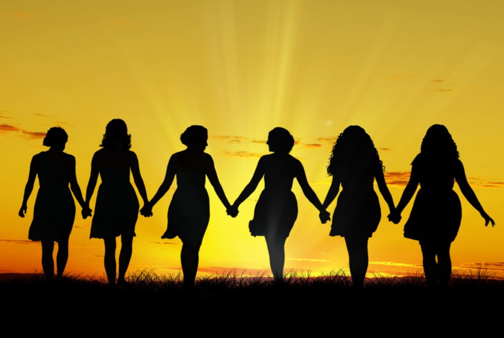 women together against a gold background