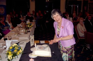 President Nora cuts the cake as the 80th birthday celebration dinner comes to an end.