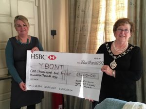 Maggs Griffiths accepts a cheque from President Sue