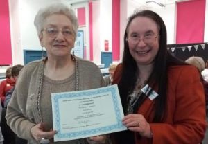 Ruthmary receiving long service certificate from President Madeleine