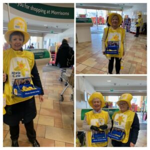 Soroptimist members in Marie Curie tabards and hats collecting donations.