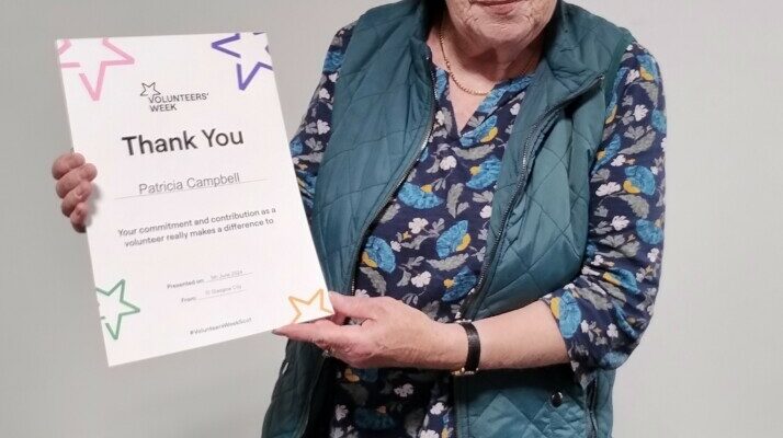 Member of the SI Glasgow City club holding a volunteer week 2024 certificate.