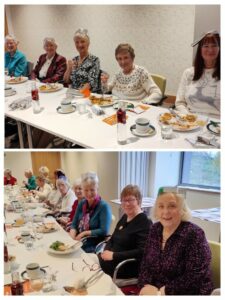 Women with Christmas hats sitting at tables.