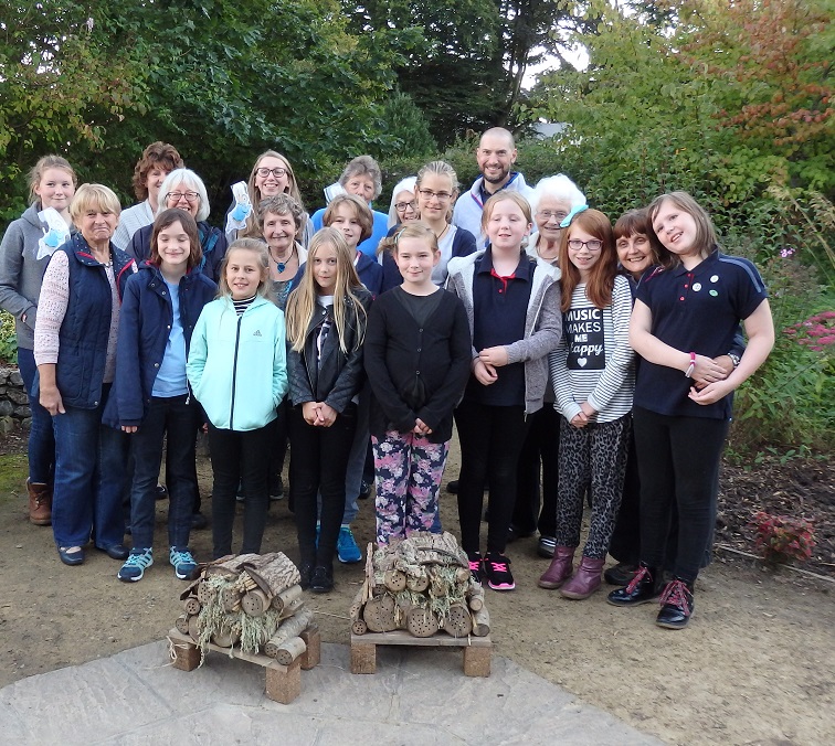 The local Guides donate and install the bug hotels they have made
