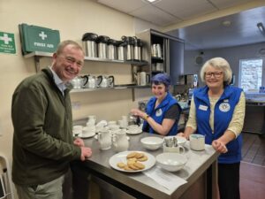 Local MP Tim Farron joins the Soroptimist team in the kitchen.