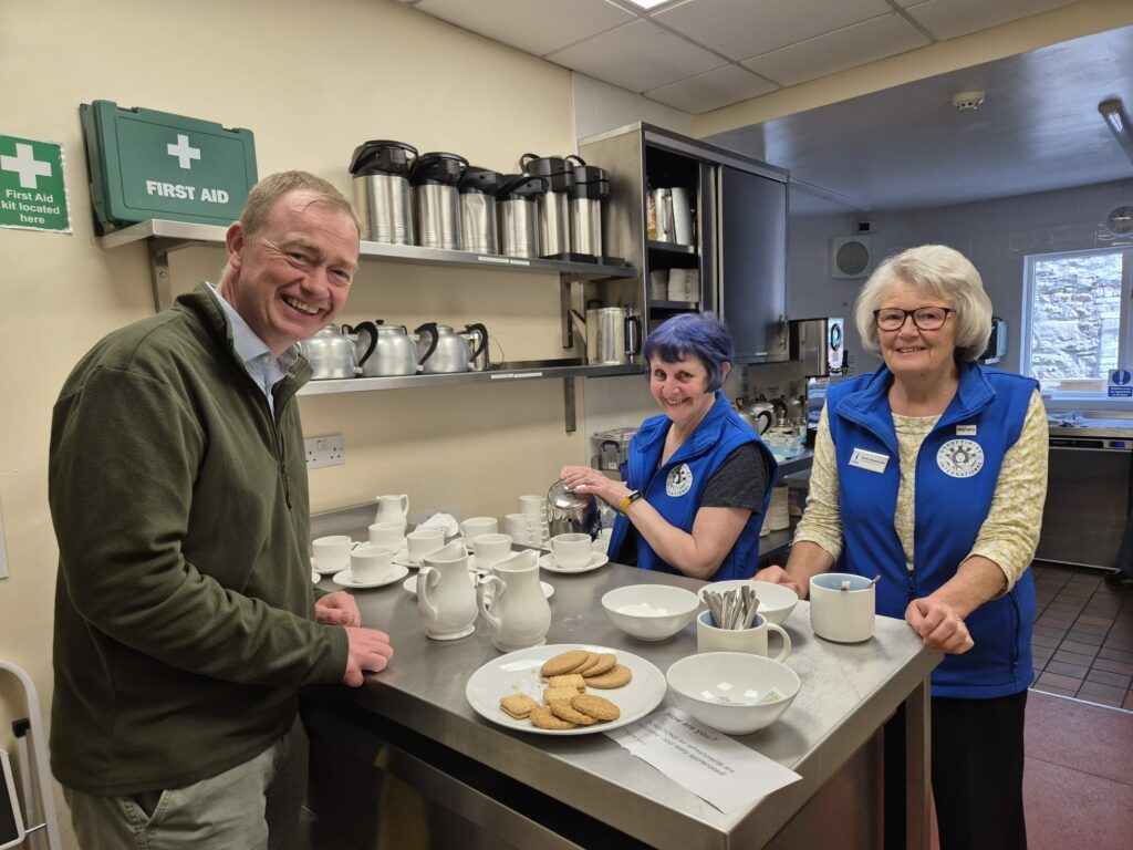 Local MP Tim Farron joins the Soroptimist team in the kitchen.