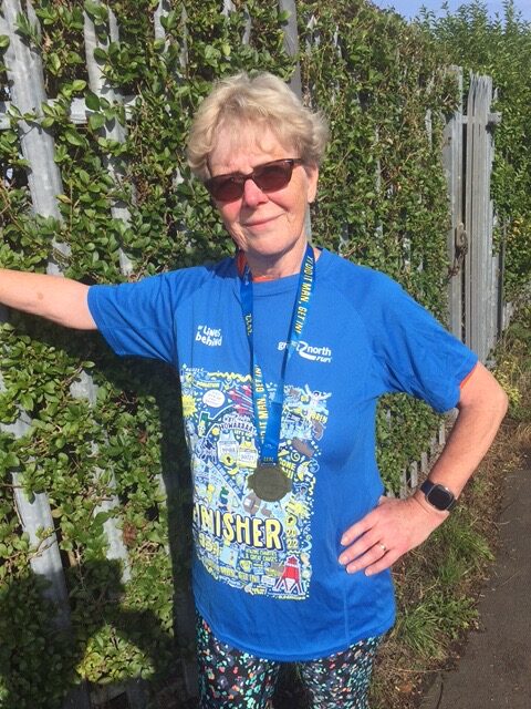 Maureen wearing her finisher t-shirt after competing the great north run