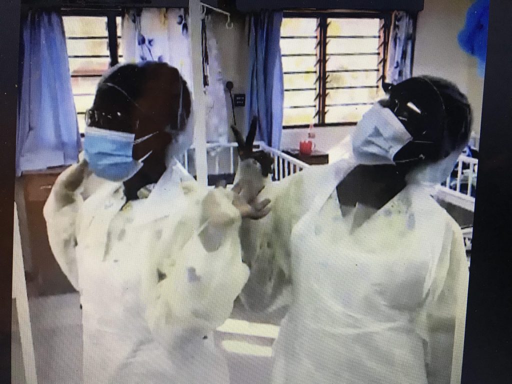Two nurses in Malawi dressed in PPE for Covid 19 protection