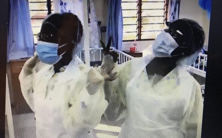 Two nurses in Malawi dressed in PPE for Covid 19 protection