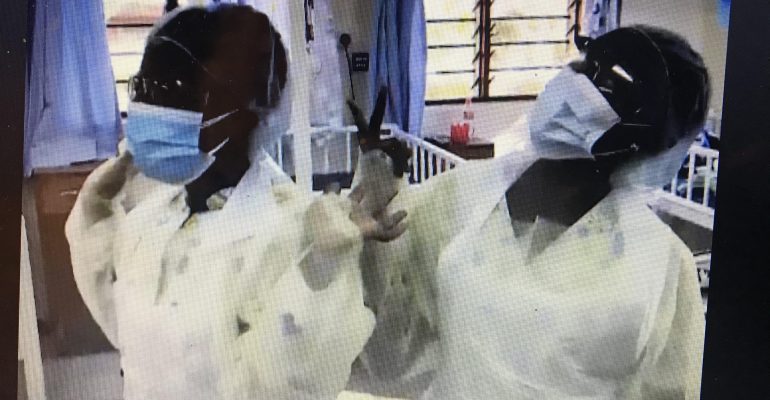 Two nurses in Malawi dressed in PPE for Covid 19 protection