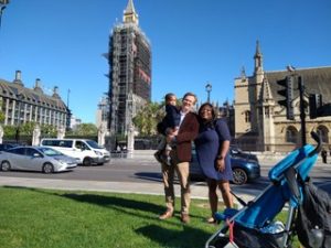 Couple with young child in man's arms outside the Houses of Parliament