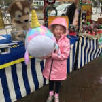 Little girl holding large soft toy