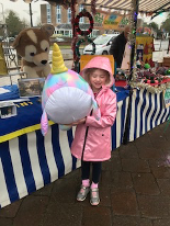 Little girl holding large soft toy