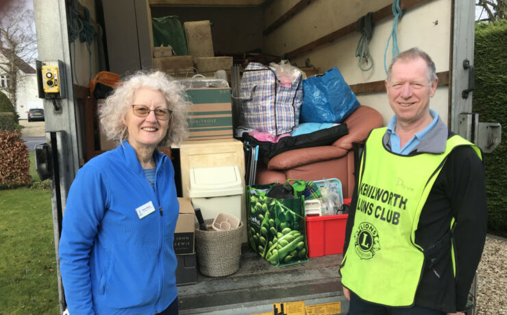 Soroptimist and a Lion standing outside a van full of furniture