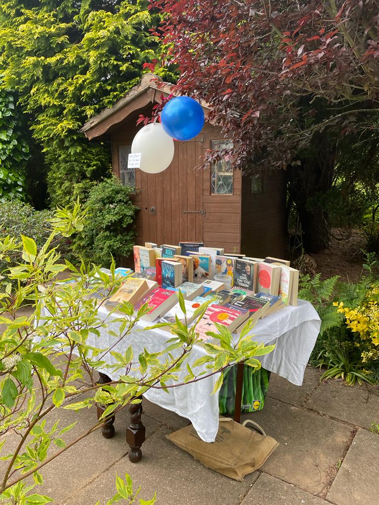 table with paperback books on it