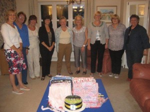 Club members and friends from the Sewing Bee toast their success