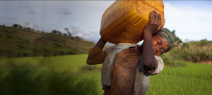 Solo carrying dirty water to her family