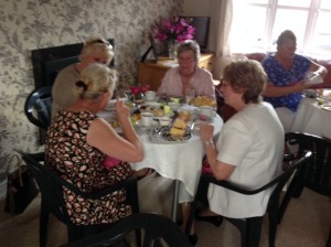 Guests enjoying afternoon tea and champagne