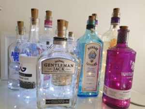 Gin bottles repurposed as lamps for charity