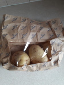 Photo of potatoes in a paper bag with a plastic window