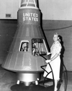 Photo of Jerrie Cobb with the Mercury Capsule