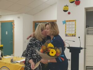 SI Lisburn and District president Karen Elliott presenting a bouquet of flowers to outgoing NI president Barbara Carlisle