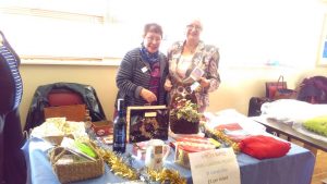 Elaine and Sandra selling raffle tickets for the Meru Garden Project.