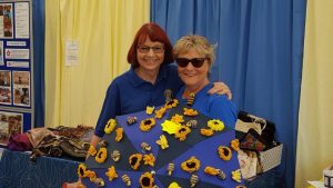 Janet and Stephanie helping to promote Soroptimist projects in our hospital;lity tent.