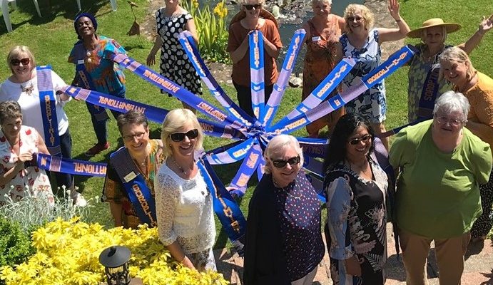 Soroptimists holding Kente sashes at Garden party 5 June 21