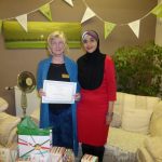 President Uzma Kazmi Presenting a Certificate to Carol Singer