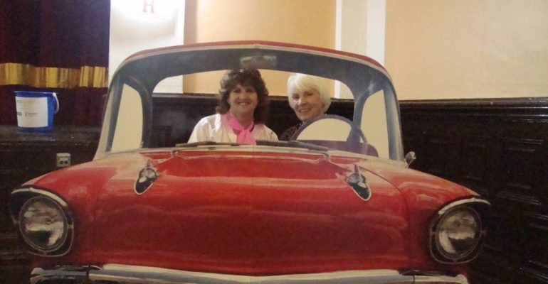 Grange Soroptimists President Lesley and Regional President Margaret pose in the car at Grease!