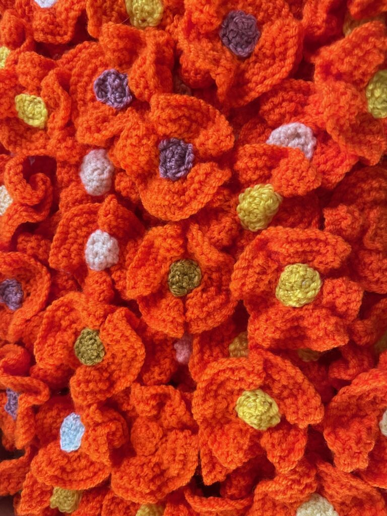 When and Where are Knitted Orange Flowers on Sale for Women’s Aid?