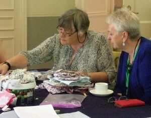 Presidents Margaret Emsley and Yvonne Simpson sewing in Warrington